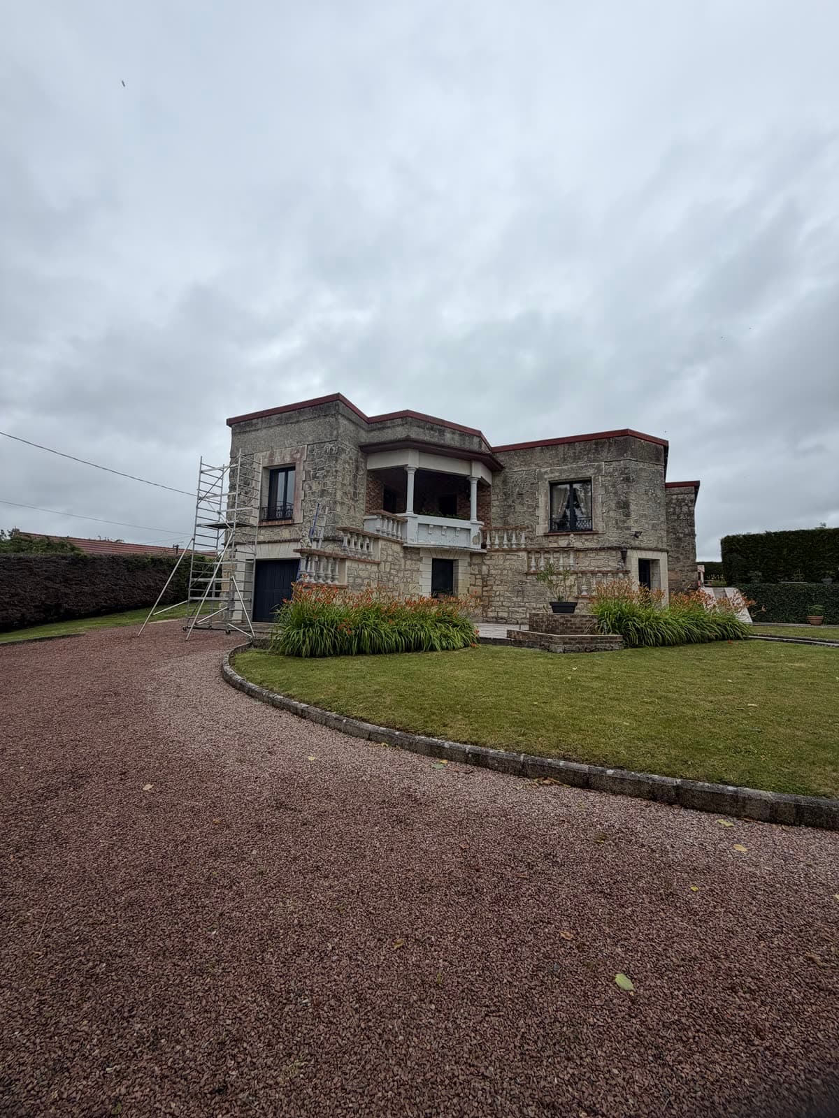 Maison en pierre naturelle grisée par les mousses et la pollution avant nettoyage de façade
